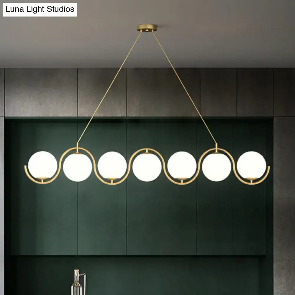 Modern gold-toned DecorBites™ hanging lamp with five clear milk white glass shade bulbs in a wavy metallic design
