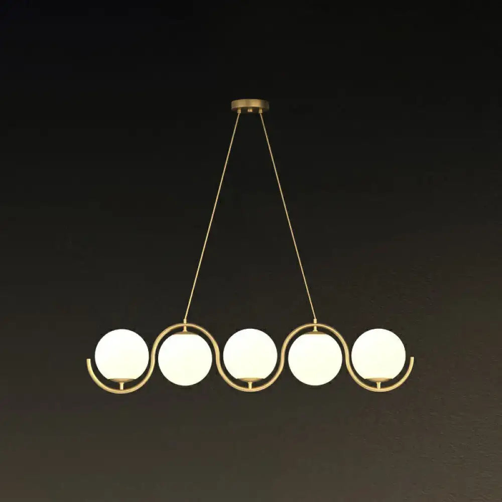 Gold-toned DecorBites™ postmodern hanging lamp with clear milk white glass shade and five frosted globe lights suspended by chains