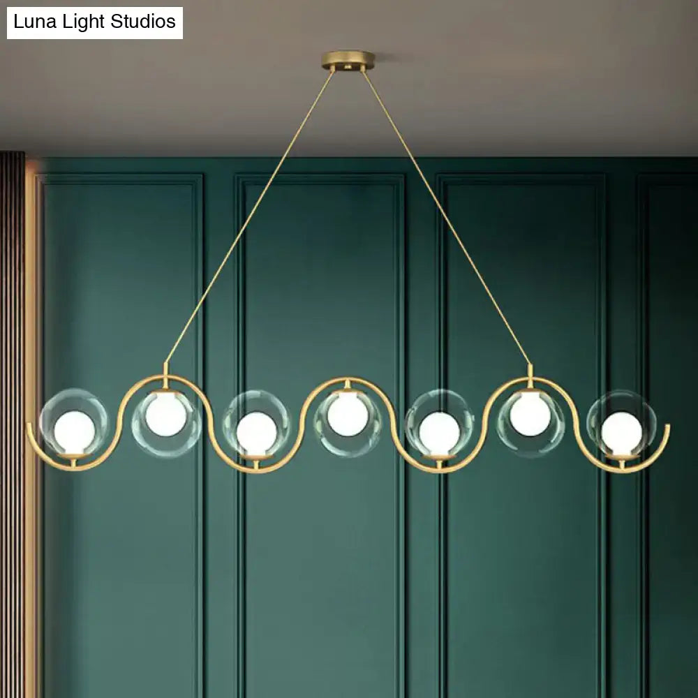DecorBites postmodern hanging lamp with gold-toned metal wave design and clear glass shade featuring bright bulbs