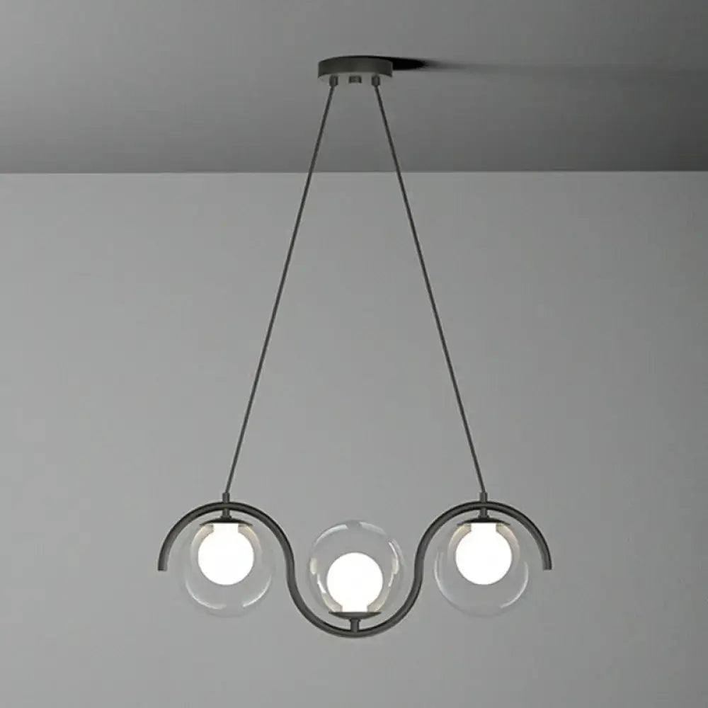 Modern black metal pendant hanging lamp with three clear glass globe bulbs and wavy glass shade by DecorBites