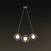 DecorBites modern brass hanging lamp with three clear glass shade spheres and curved metallic arms
