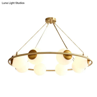 Decorbites™ postmodern circular chandelier light with brass finish and frosted glass globe shades suspended by chains
