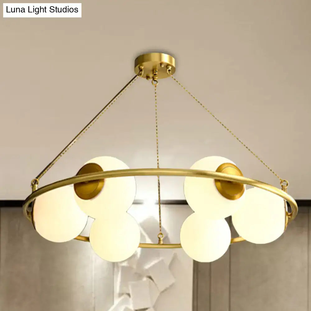 Modern decorbites brass finish circular chandelier light with frosted glass globe shades and metal frame