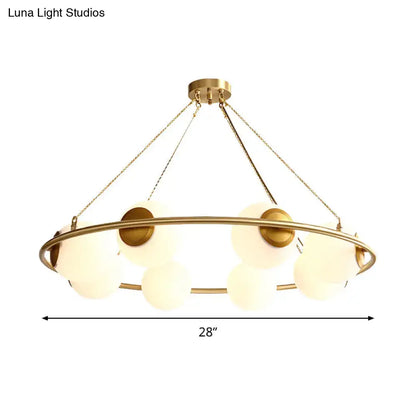 Decorbites postmodern circular chandelier light with brass finish and frosted glass globe shades suspended by chains