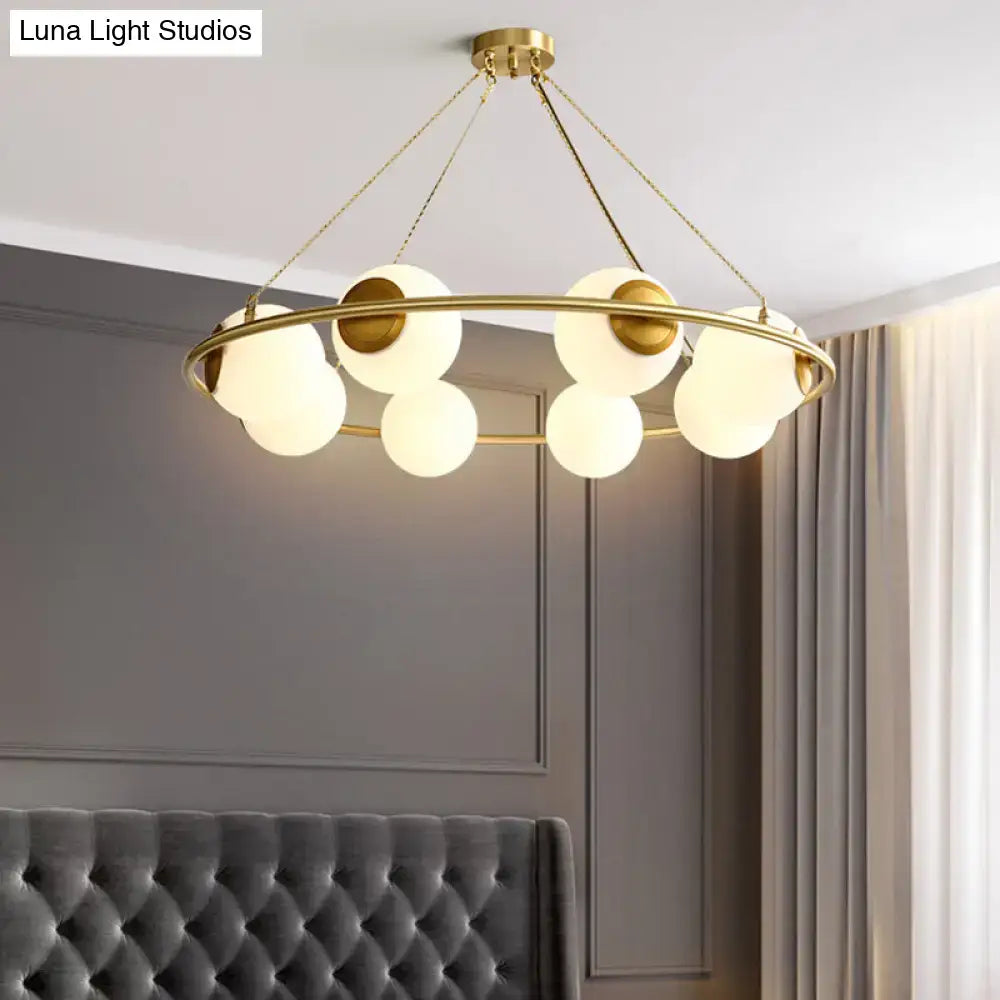 Decorbites™ postmodern circular chandelier light with brass finish and frosted glass spherical shades suspended by chains