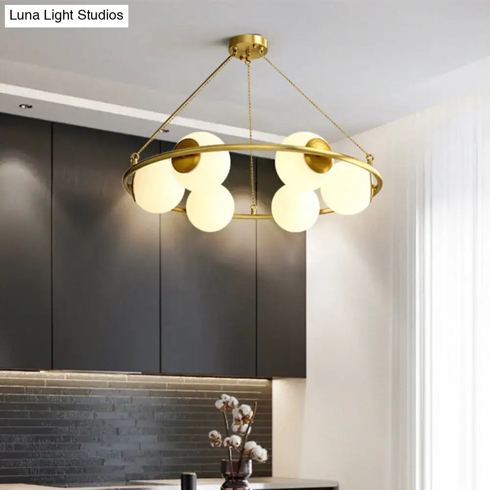 Decorbites™ postmodern gold-toned circular chandelier light with brass finish and six frosted glass globe shades