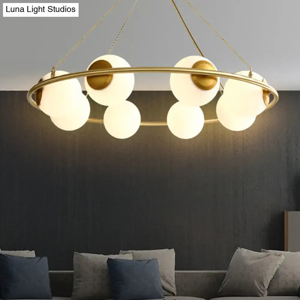 Decorbites postmodern circular chandelier light with brass finish and frosted glass shades featuring six white globes