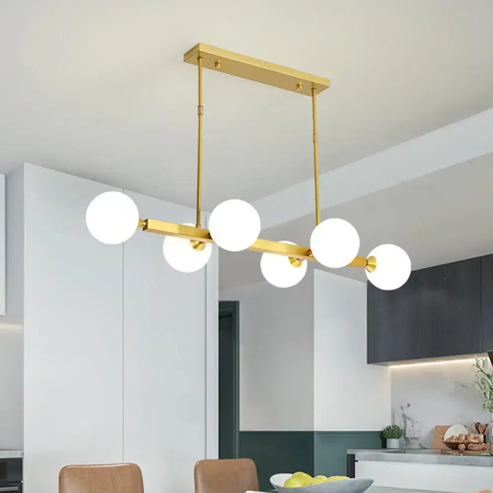Gold-toned DecorBites™ postmodern pendant light with five opaline glass molecular bulbs for dining room use