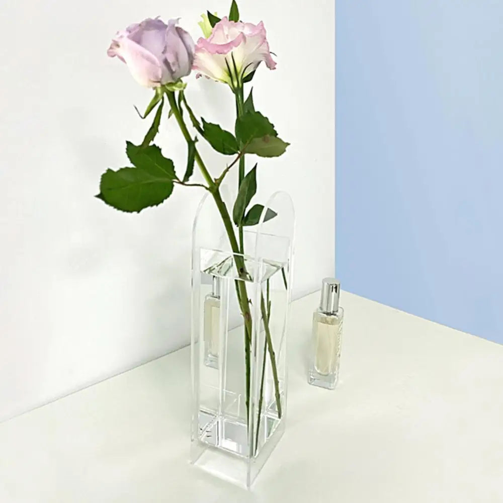Clear acrylic rainbow color flower vase in nordic style with a modern geometric design holding two pink roses
