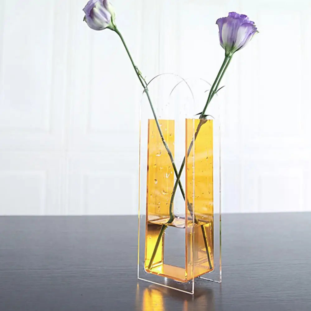 Transparent acrylic flower vase with rainbow color geometric design in nordic style holding two purple flowers