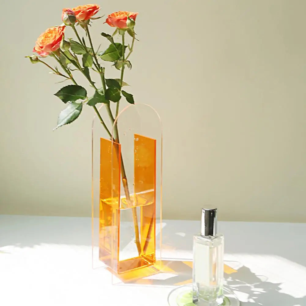 Transparent orange acrylic flower vase with sleek arched top and vertical cutouts in nordic style by DecorBites rainbow color