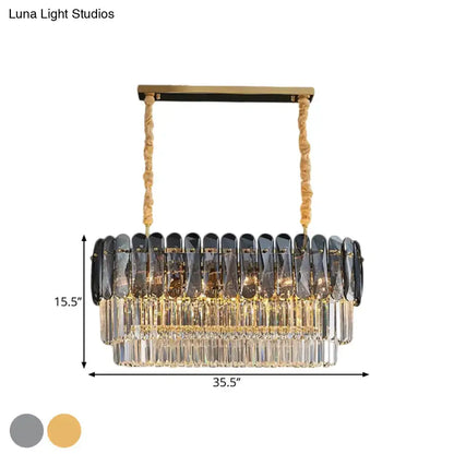 Elegant rectangular dining room pendant with smoke gray and clear crystal droplets on gold-toned frame and twisted ropes