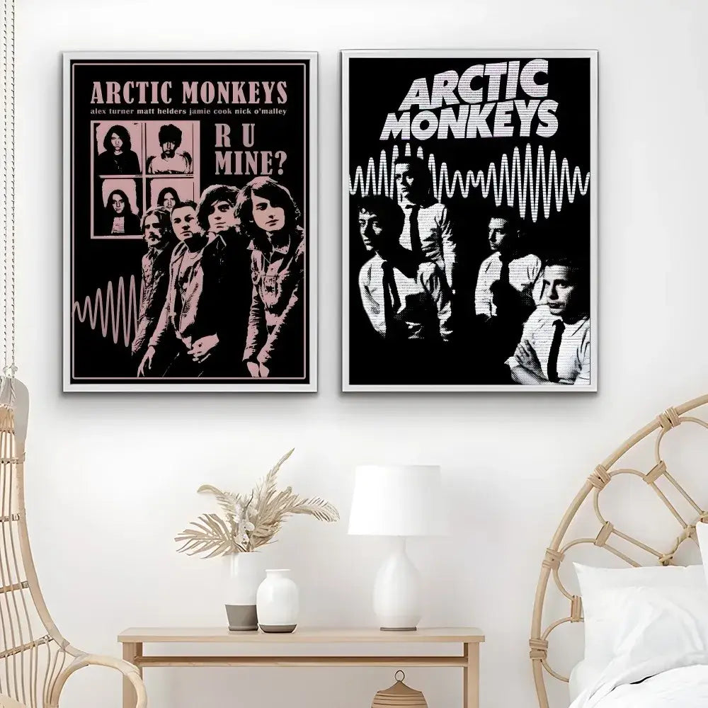 Two framed retro Arctic Monkeys wall art posters in pink black and black white featuring band portraits and wave patterns