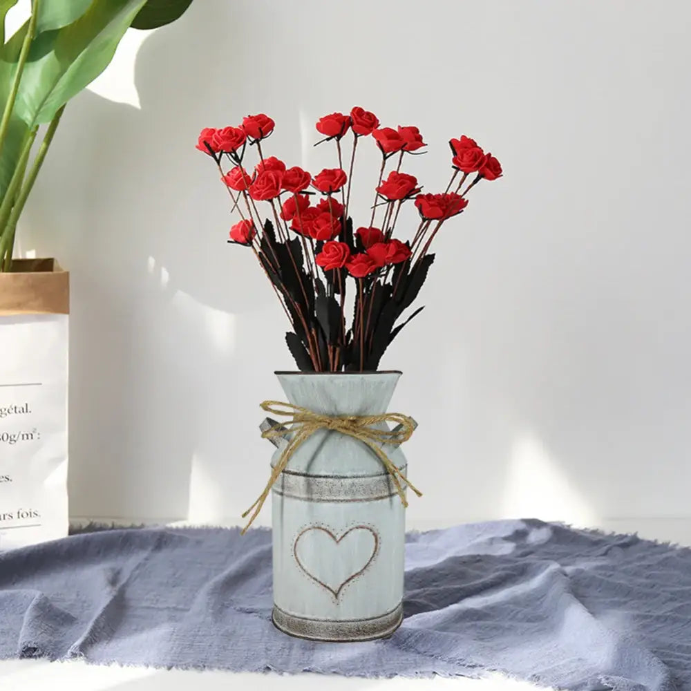 DecorBites™ retro floral light blue metal vase holder with heart design and twine tie holding red artificial roses