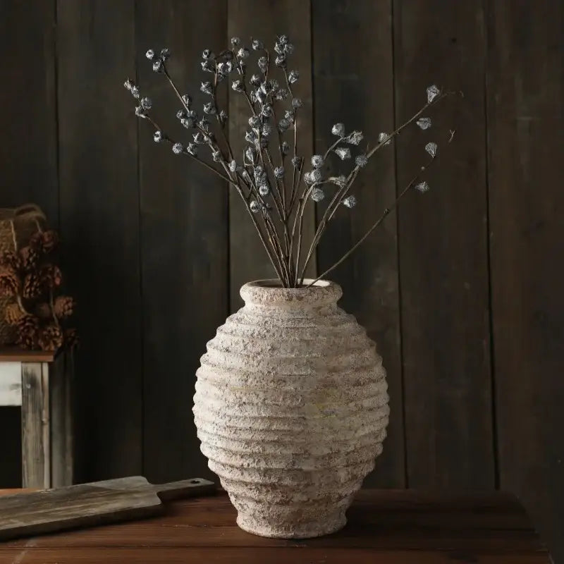 DecorBites™ retro handmade clay vase 21.5cm in off-white with textured ribbed surface holding silver-toned branches
