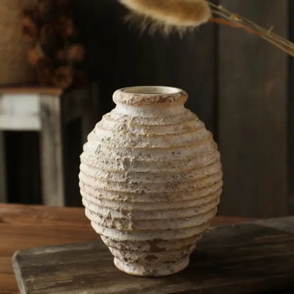 DecorBites™ retro handmade off-white clay vase with horizontal ridges and weathered texture on wooden surface