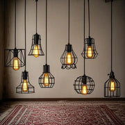 Decorbites™ retro iron art pendant light with black wrought iron cage and glowing amber filament bulbs in vintage style