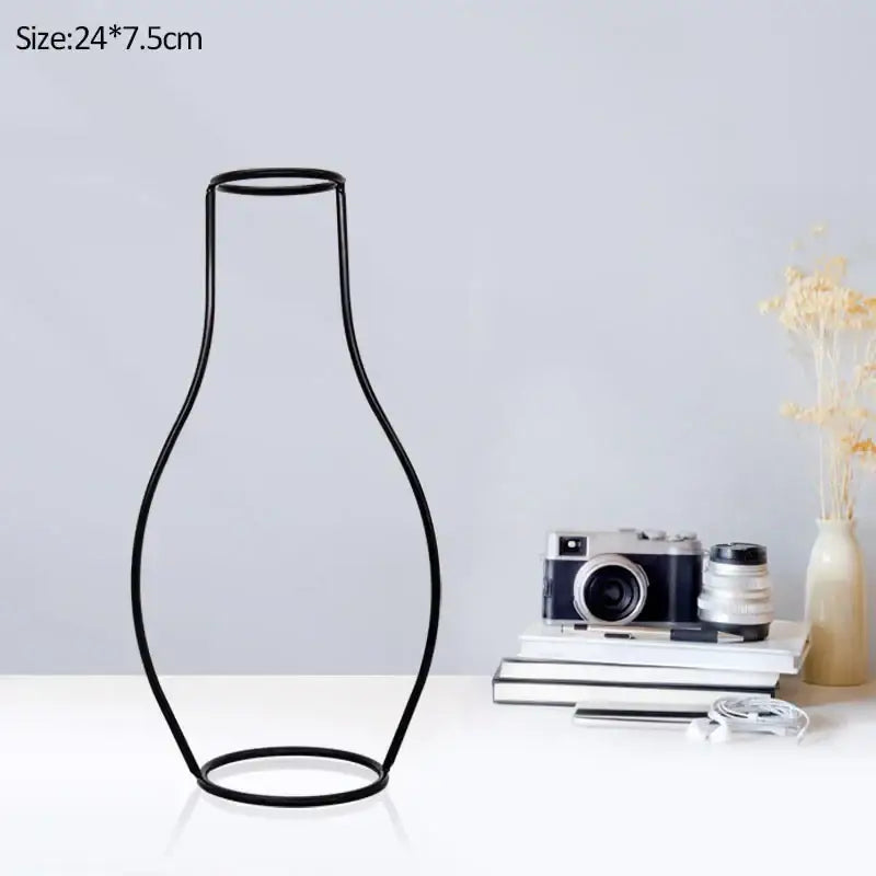 Black wireframe retro iron flower vase with sleek minimalist design and rounded contours for home and garden decor