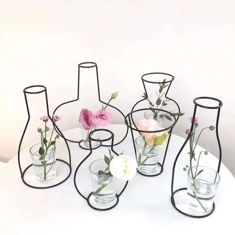 DecorBites™ retro iron flower vase features black wireframe pots with glass bases holding pink and white flowers