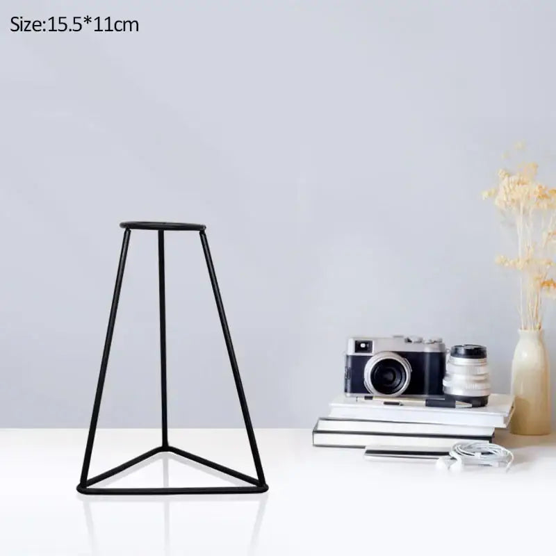Black metal tripod stand supporting DecorBites™ retro iron flower vase pot ornament for home and garden display
