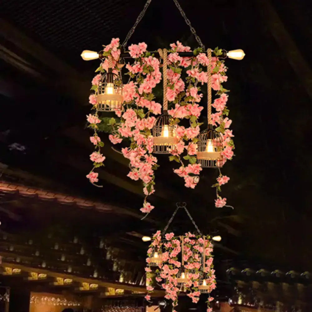 DecorBites™ retro metal island light with three black birdcages, pink flower drops, and warm bulbs for restaurants