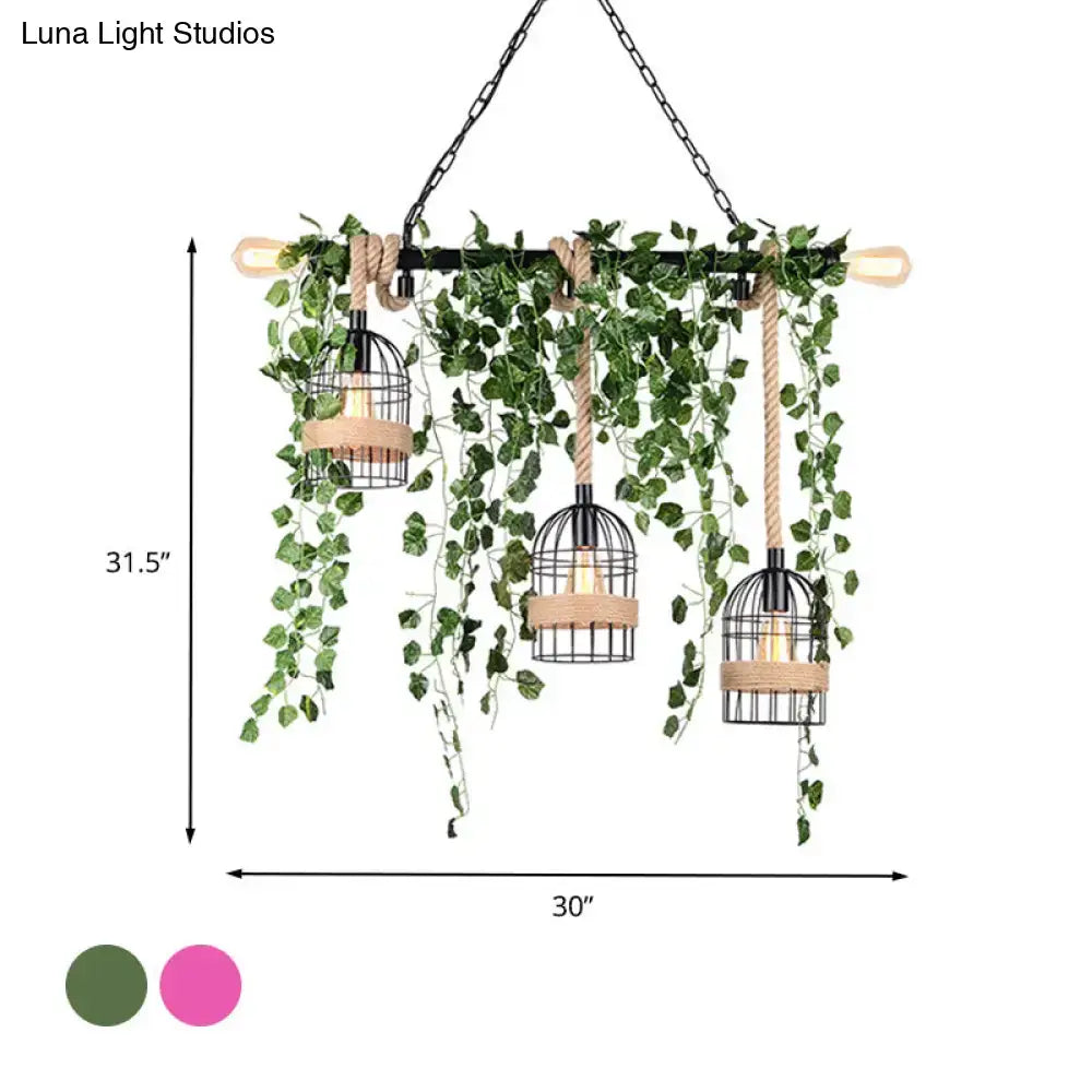 Black metal birdcage pendant light with hanging green ivy and beige rope accents from decorbites™ retro metal island light with pink and green flower drops for restaurants