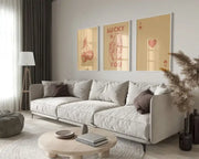 Light gray upholstered sectional sofa with dark brown throw pillows next to DecorBites™ retro queen of hearts wall art set