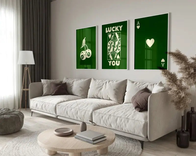 Three framed green DecorBites™ retro queen of hearts wall art posters hang above the sofa as stylish wall art