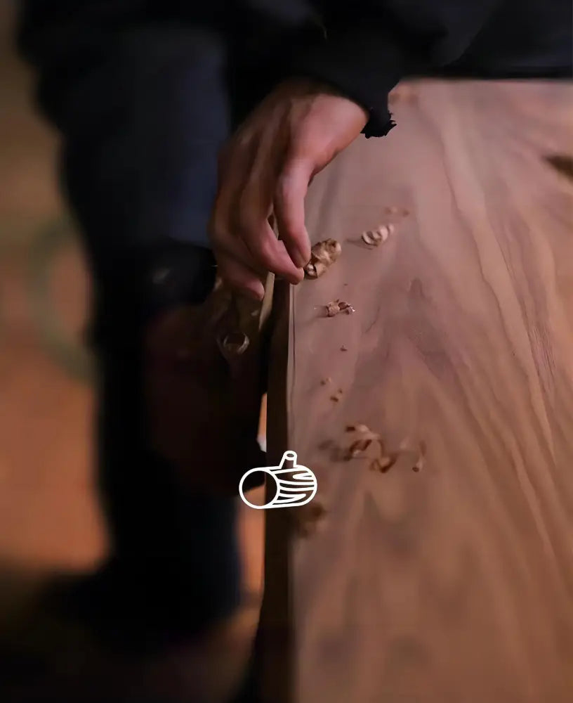 A hand-shaped wooden carving tool with visible wood grain used in decor for a walnut color living room ceiling light