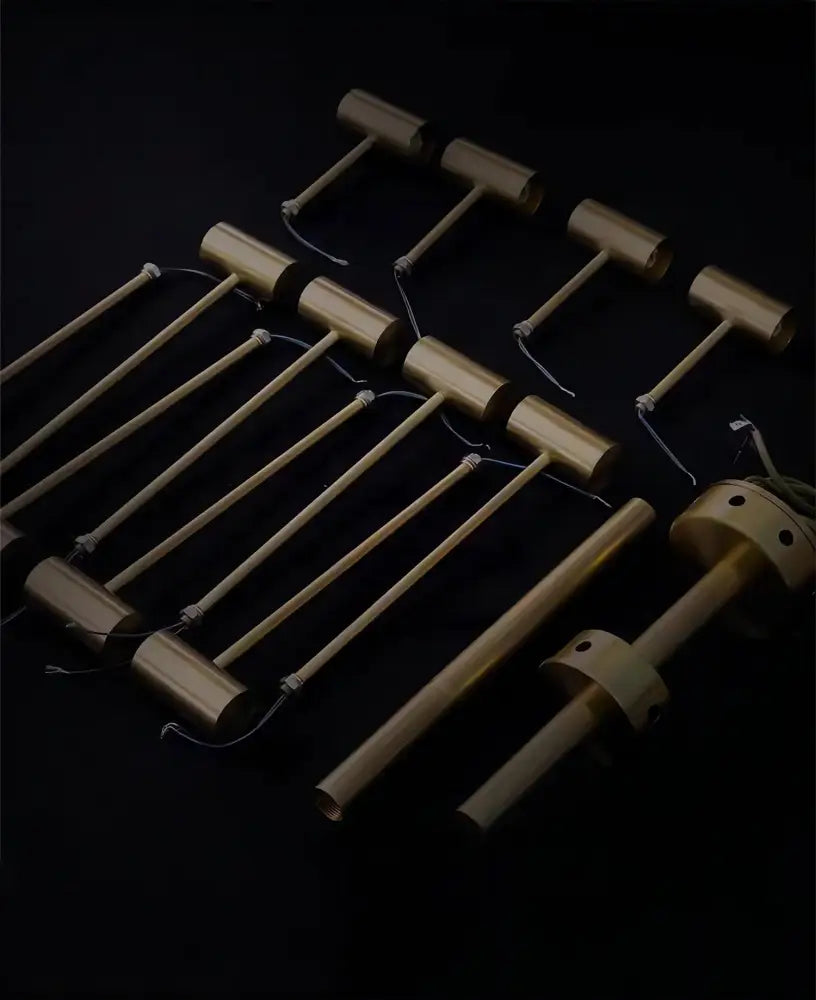 Set of brass-colored cylindrical mallets with wooden handles for decorbites™ retro-style walnut acrylic ceiling light in living room
