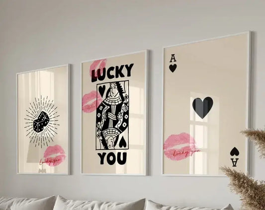 Three framed decorbites™ retro wall art posters set featuring black and pink poker-themed designs on cream background