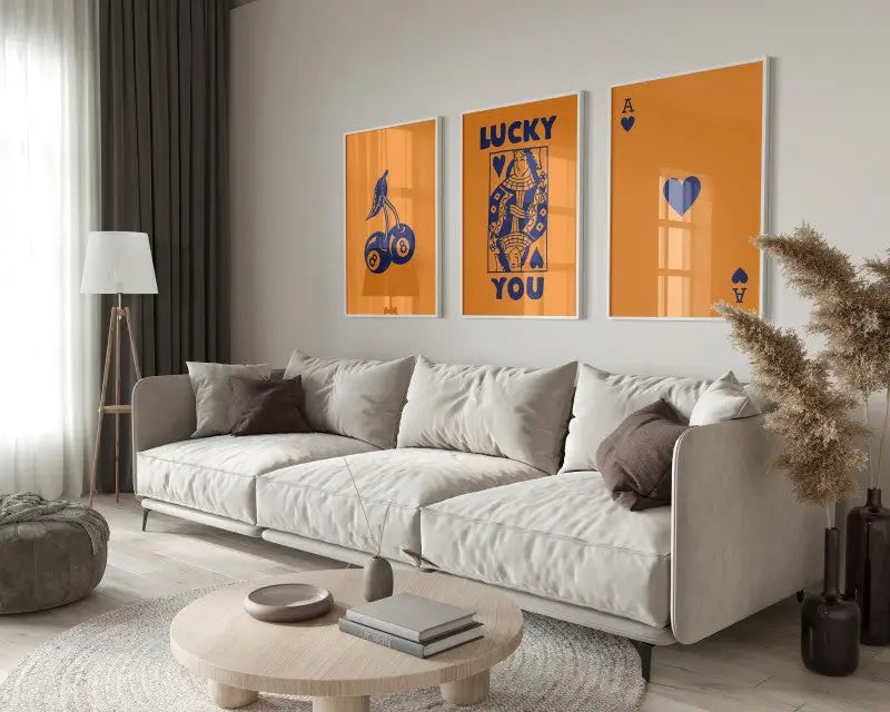 Modern beige sectional sofa with soft upholstered cushions and metal legs next to decorbites™ retro wall art posters set queen of hearts-ace canvas
