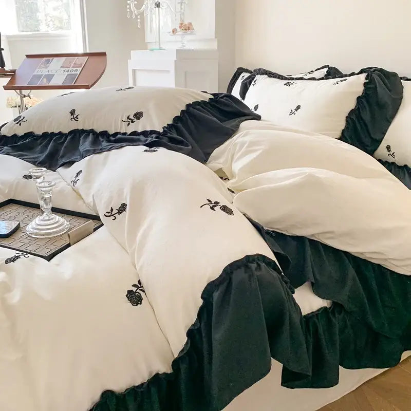 Cream-colored DecorBites™ rose embroidered duvet cover set with black ruffled trim in princess style cover set