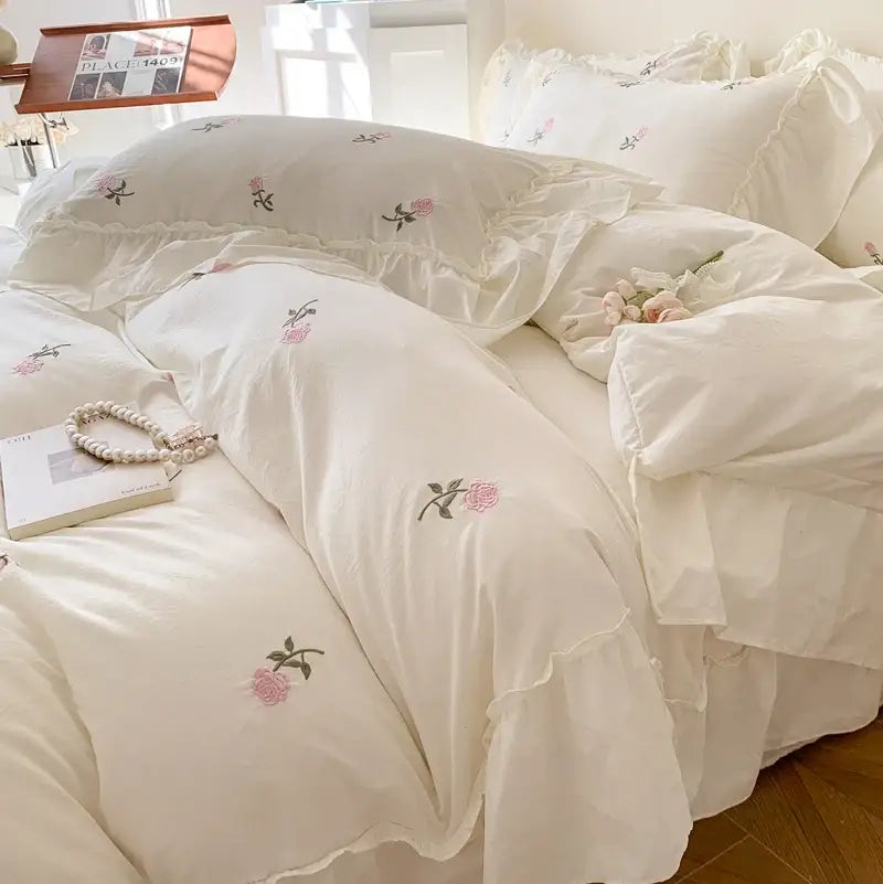 Cream-colored duvet cover set with delicate pink rose embroidered design and ruffled edges by decorbites princess style