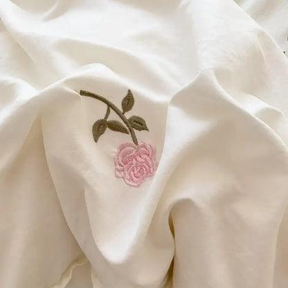 Delicate pink rose embroidered duvet cover set with green stem on soft white fabric by DecorBites princess style