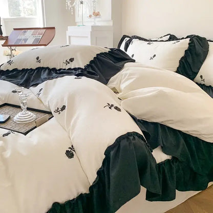 Cream-colored decorbites rose embroidered duvet set with black ruffled trim and embroidered rose motifs princess style