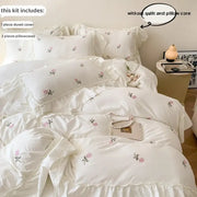 White floral rose embroidered duvet cover set with ruffled edges and matching pillowcases by decorbites princess style