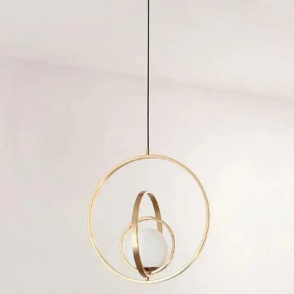 Decorbites™ rotating gold ring pendant light with intersecting rings and frosted glass globe in gold-toned finish