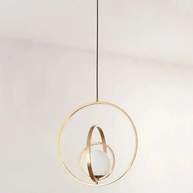 Decorbites™ rotating gold ring pendant light with intersecting rings and frosted glass globe in gold-toned finish
