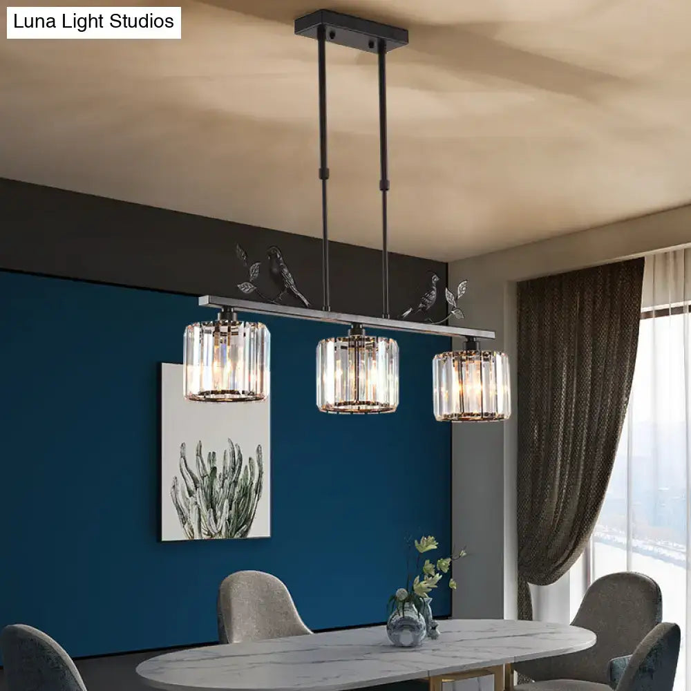 Modern black metal chandelier with three cylindrical crystal glass shades and decorative bird motifs for dining room crystal island lighting