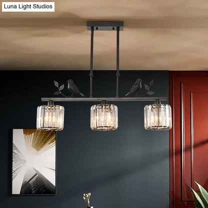 Black metal pendant light with three cylindrical crystal bulbs and decorative bird motifs for dining room crystal island lighting