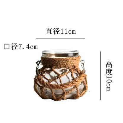 DecorBites Rustic hanging glass vase with clear glass, silver rim, woven brown hemp rope, and metal hooks on either side