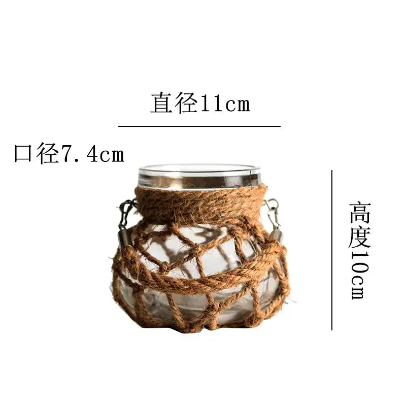 DecorBites Rustic hanging glass vase with clear glass, silver rim, woven brown hemp rope, and metal hooks on either side