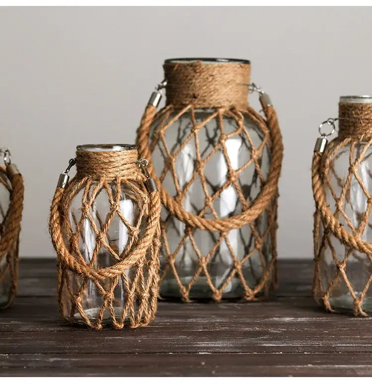 Decorbites™ rustic hanging glass vase with hemp rope features clear glass and natural brown twine net secured by metal clasps