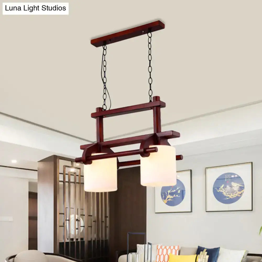 Decorbites rustic wood-framed island light with two white glass cylindrical shades for dining room lighting