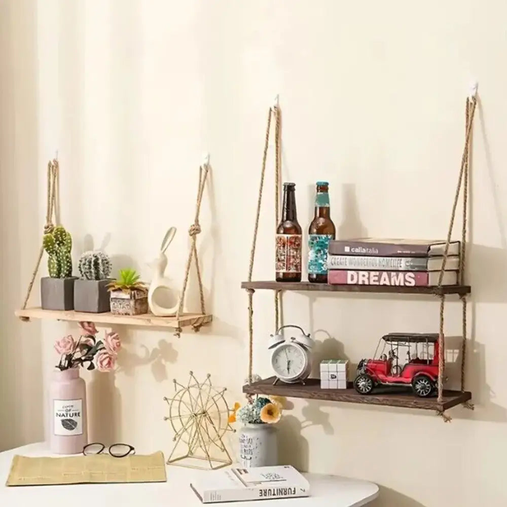 Rustic wood floating wall shelves by decorbites suspended by natural fiber ropes displaying books and decor items