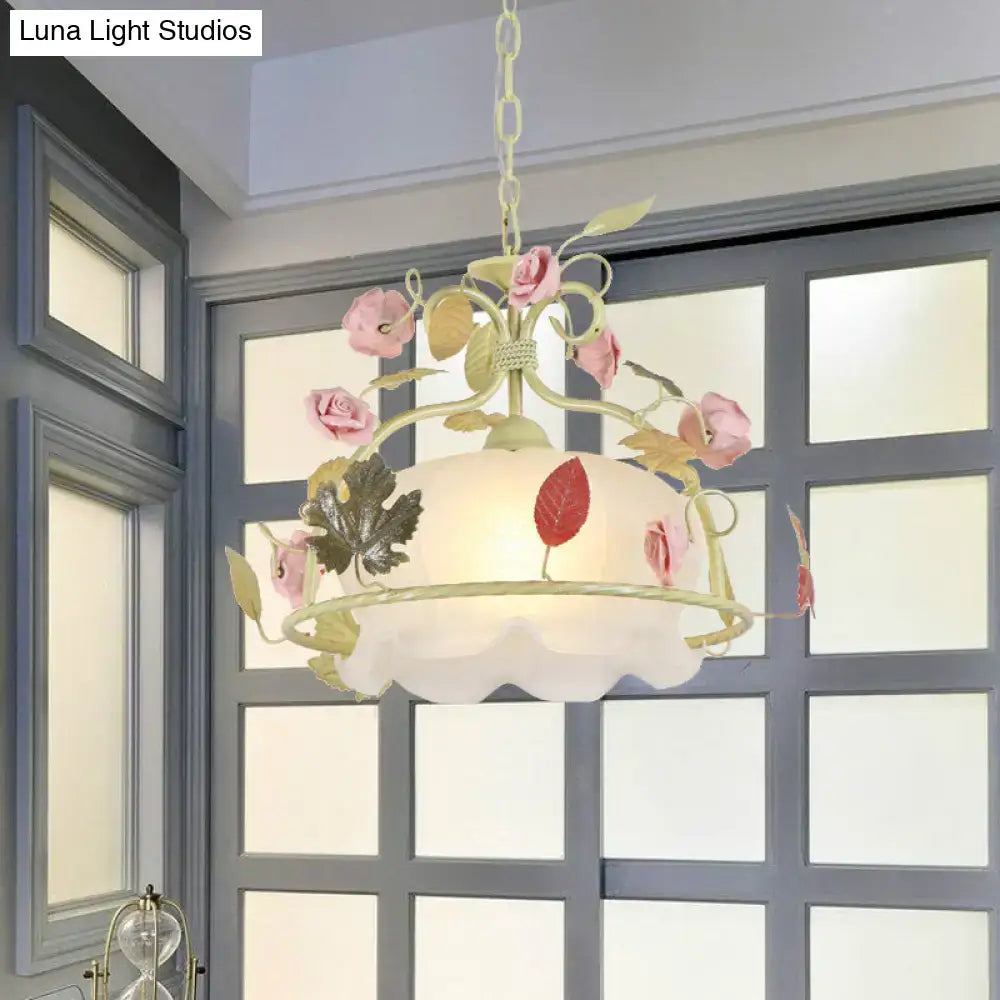 Cream-colored DecorBites scallop chandelier light fixture with pink floral accents and frosted opal glass shade for living room