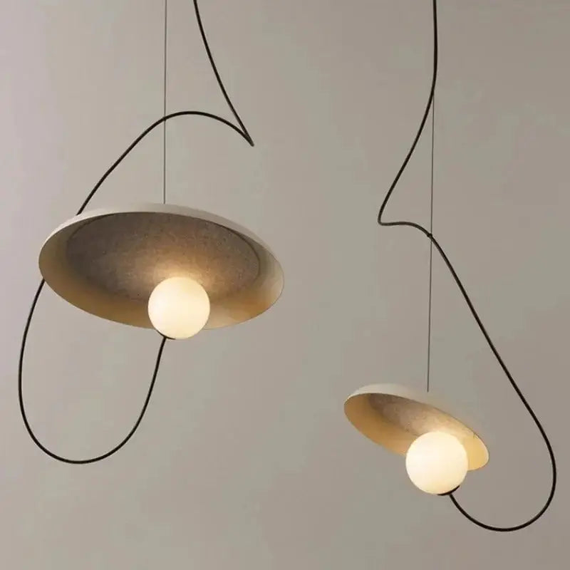 Decorbites™ scandinavian pendant light with sleek black wire frames and matte gold circular shades featuring warm globe bulbs