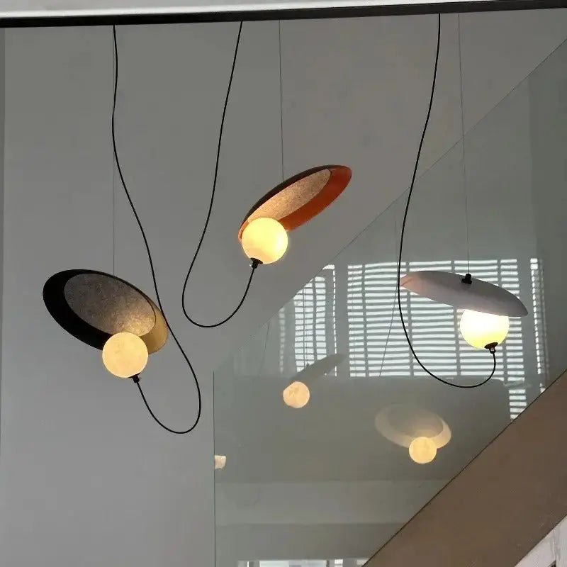 DecorBites™ scandinavian pendant light with sleek matte black and warm copper oval metal shades and glowing bulbs
