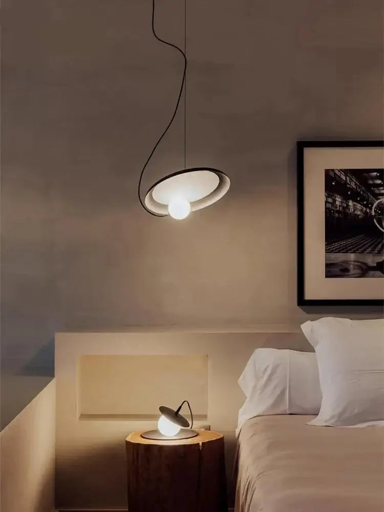 DecorBites™ scandinavian pendant light with sleek black frame and frosted glass shade above bedside table